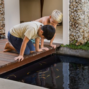 kids at fishpond of Villa Kubu, Seminyak, Bali